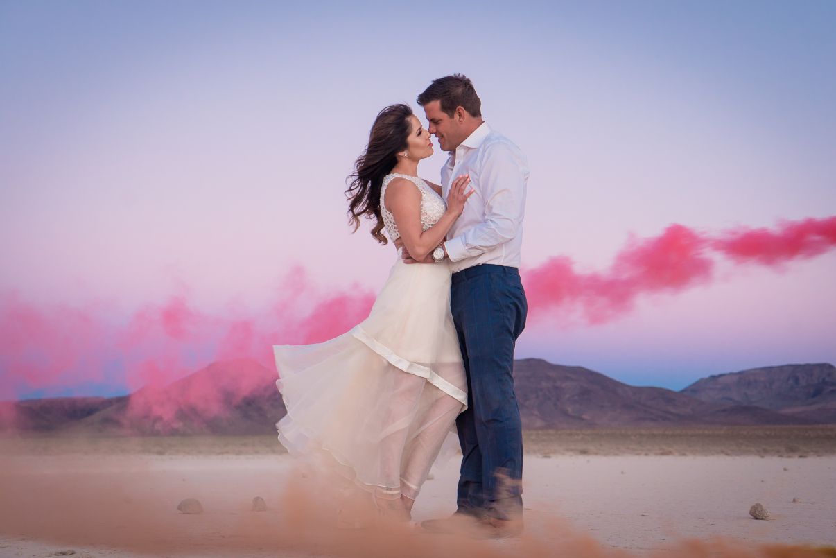 Couple photoshoot outdoors with pink dust