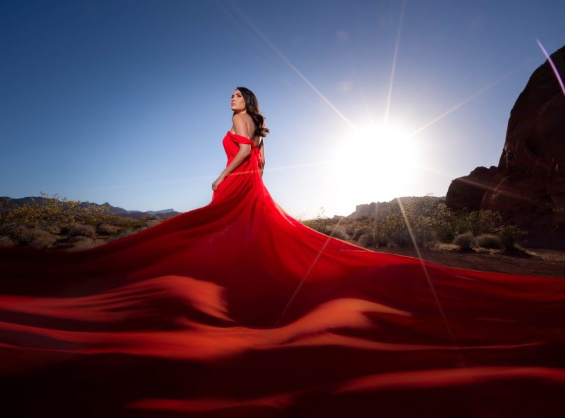 glamour photoshoot of woman in red dress, strong woman photoshoot