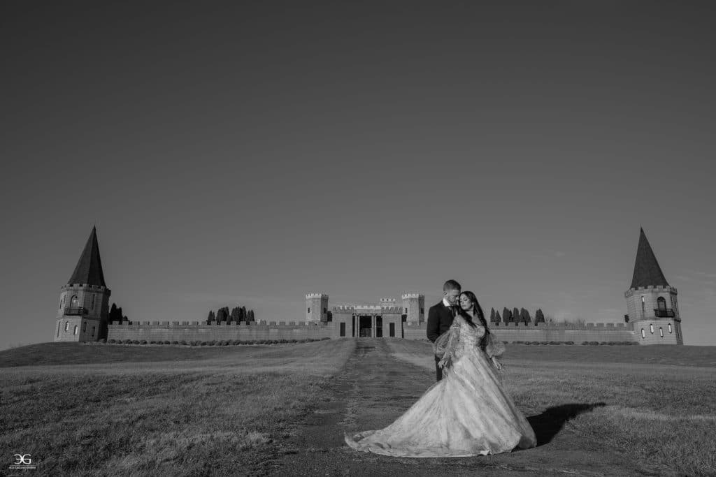 Bride and groom embracing in front of The Kentucky Castle in Versailles, Kentucky