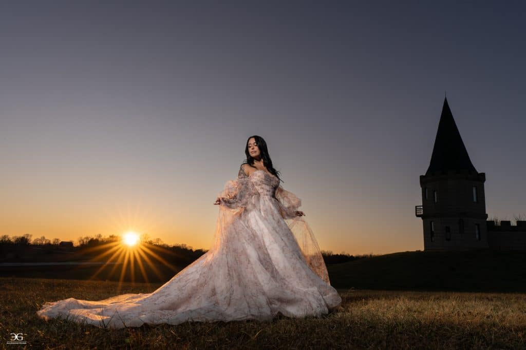 Bride in a flowing wedding gown at sunset outside The Kentucky Castle in Versailles, Kentucky
