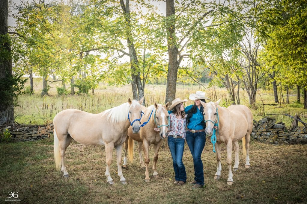 Teen girl and her mentor standing together with three horses on a Kentucky farm